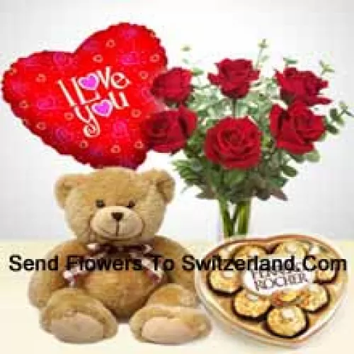 7 Red Roses With Some Ferns In A Glass Vase, A Cute 14 Inches Tall Brown Teddy Bear, 8 Pcs Heart Shaped Ferrero Rocher And An "I Love You" Balloon