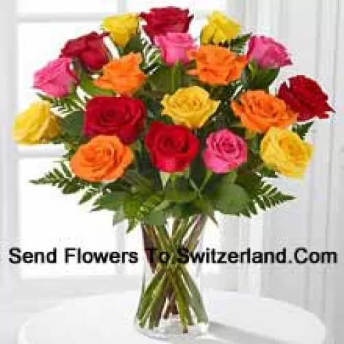 19 Mixed Colored Roses With Seasonal Fillers In A Glass Vase