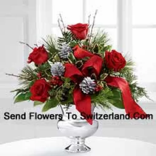 Highly elegant and bursting with your merriest wishes, this bouquet will create the perfect holiday gift. Rich red roses are vibrant and bright arranged with variegated holly, assorted holiday greens, silver pinecones and branches, all perfectly accented with a faux cardinal and designer red ribbon. Presented in a silver pedestal vase, this bouquet will add to the joy and festivities of their holiday season with each gorgeous bloom. (Please Note That We Reserve The Right To Substitute Any Product With A Suitable Product Of Equal Value In Case Of Non-Availability Of A Certain Product)