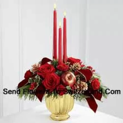 The grandeur and rich beauty of the Christmas season are highlighted with each crimson bloom. Bright red roses and spray roses are arranged in a designer gold container amongst variegated holly and assorted holiday greens. Accented with artificial apples, gold pinecones and gold-edged burgundy ribbon, this gorgeous centerpiece displays three red taper candles to create the perfect atmosphere for their holiday celebration.? (Please Note That We Reserve The Right To Substitute Any Product With A Suitable Product Of Equal Value In Case Of Non-Availability Of A Certain Product)