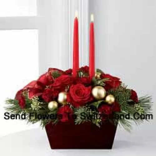 An exquisite display of holiday beauty to add warmth and cheer to their special celebrations. Rich red roses and burgundy mini carnations are set to impress surrounded by lush holiday greens, seeded eucalyptus, gold glass balls and a gold-edged red ribbon arranged elegantly around two red taper candles. Presented in a chocolate brown bamboo?container, this centerpiece will usher in joy and goodwill with each treasured bloom (Please Note That We Reserve The Right To Substitute Any Product With A Suitable Product Of Equal Value In Case Of Non-Availability Of A Certain Product)